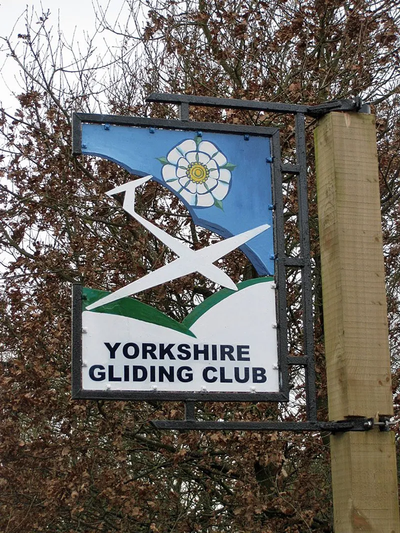Sign for the Yorkshire Gliding Club. If memory serves, the sign was different in 1987. © Copyright Pauline E and licensed for reuse under the Creative Commons License